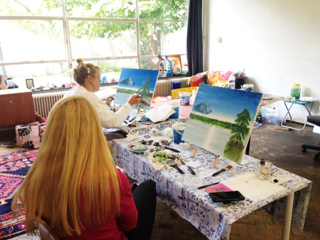 participants are painting their Bob Ross painting